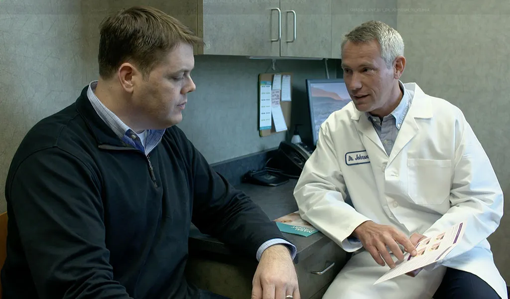 Minnesota ENT physician speaking with a patient during a consultation about ear, nose, and throat care options.