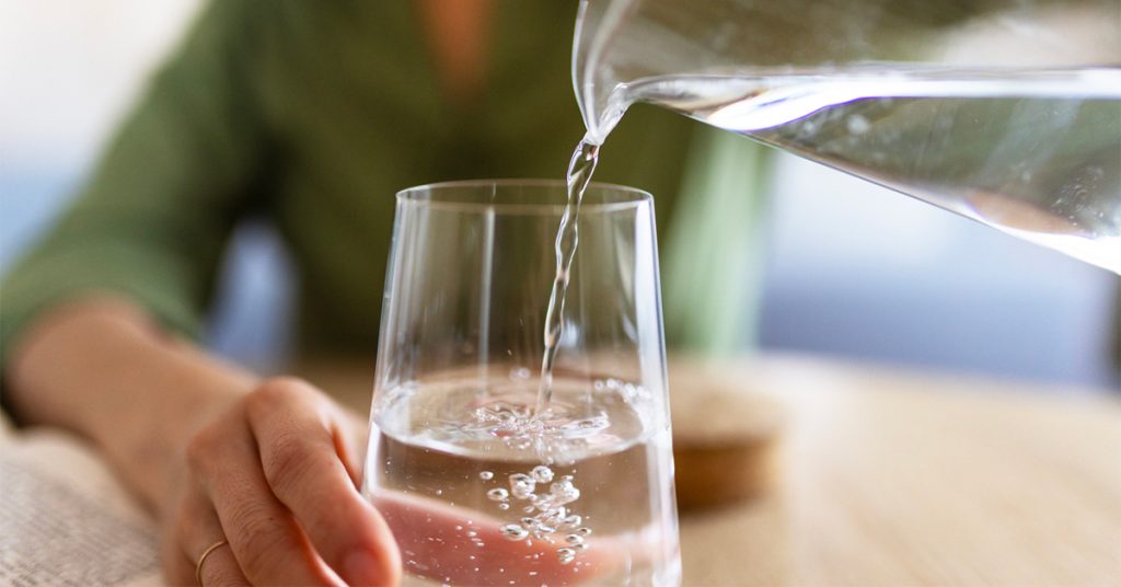 Sip_water Woman pouring water into a glass