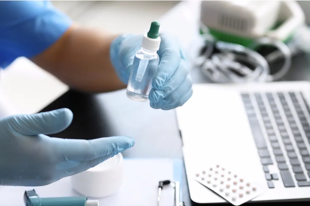 Allergy drop bottle and medical supplies illustrating sublingual drops and allergy shot treatment options