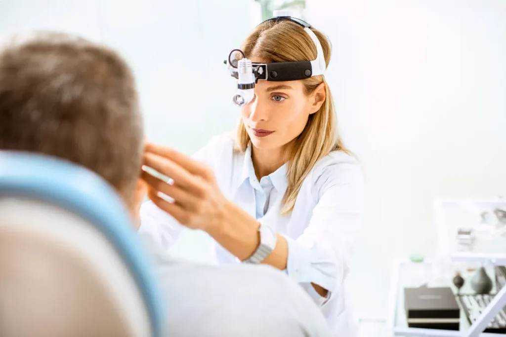 ENT specialist evaluating a patient before balloon sinuplasty procedure for chronic sinusitis treatment